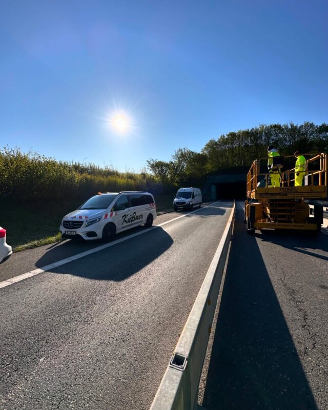 „Die 1997 und 1998 erbauten Autobahntunnel Olpe (512 Meter) und Hemberg (397 Meter) liegen im Sauerland auf der A46 zwischen den Anschlussstellen Wennemen und Freienohl. Da sie nur wenige Hundert Meter voneinander trennen, wird die grundhafte Modernisierung beider Tunnel, die jeweils aus einer Röhre pro Fahrtrichtung bestehen, in einem Projekt angegangen. Im Wesentlichen wird die vorhandene Betriebstechnik in großen Teilen renoviert und erweitert. Die Beleuchtung wird auf dynamische LED-Technik umgestellt, die an die Lichtverhältnisse außerhalb des Tunnels angepasst werden kann. Dadurch haben Verkehrsteilnehmerinnen und Verkehrsteilnehmer bei der Einfahrt in den und Ausfahrt aus dem Tunnel weniger Probleme mit unterschiedlichen Lichtverhältnissen. Um die Tunnel optisch aufzuhellen, erhalten beide Anlagen einen hellen Anstrich der Tunnelwände.

Die Modernisierung beinhaltet zudem die Erneuerung von Kabeln, der Schaltanlagen, des Brandschutzes, der Messtechnik, der Wechselverkehrszeichen sowie die Ausstattung beider Tunnel mit Sperrschranken, mit denen die Tunnel ferngesteuert für den Verkehr bei einem Unfall oder Brand geschlossen werden können. Neue Lautsprecher und digitaler Funk ermöglichen in diesem Fall künftig auch die direkte Ansprache von Personen in den Tunneln. Zudem werden Kameras installiert, über die die Tunnelleitzentrale in Hamm jederzeit nicht nur einen ohnehin vorhandenen technischen, sondern auch einen visuellen Überblick über die Geschehnisse im Tunnel hat.“ Quelle: Die Autobahn GmbH 

Wir demontieren mit mehreren Teams die Tunnelbeleuchtung und Technik um schnellstmöglich Platz für Nachfolgegewerke zu schaffen.

#Industriedemontage #tunnelrückbau #autobahn